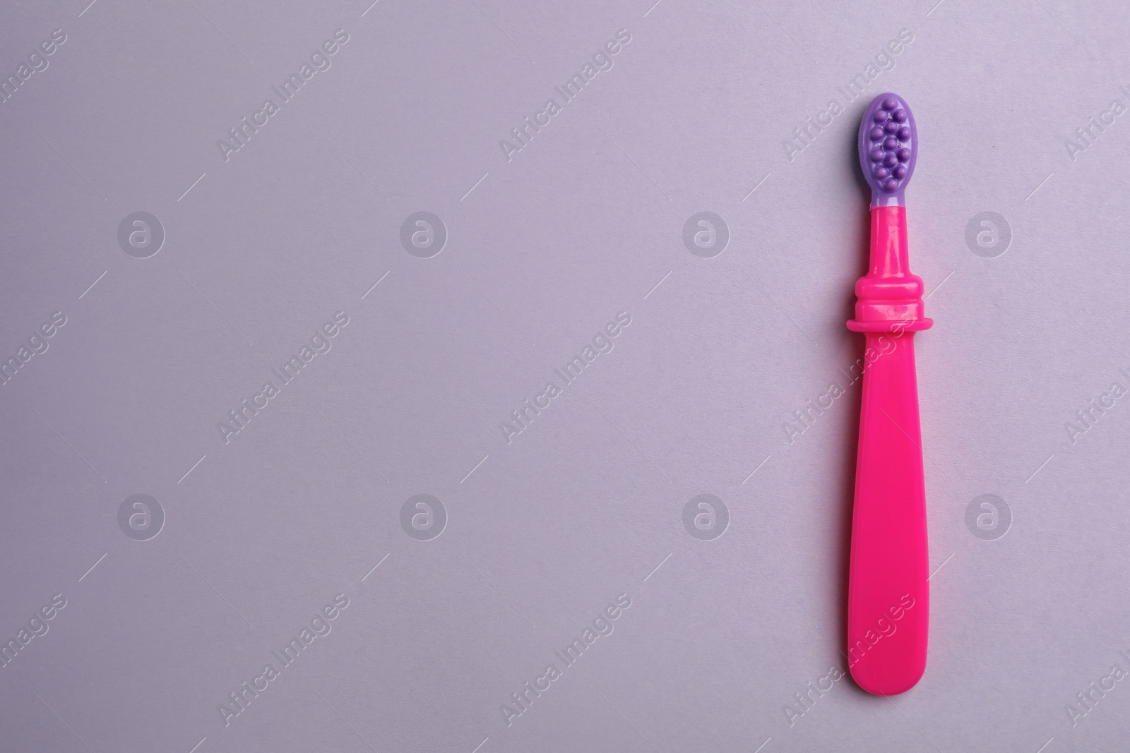 Photo of Manual toothbrush for child on color background, top view with space for text