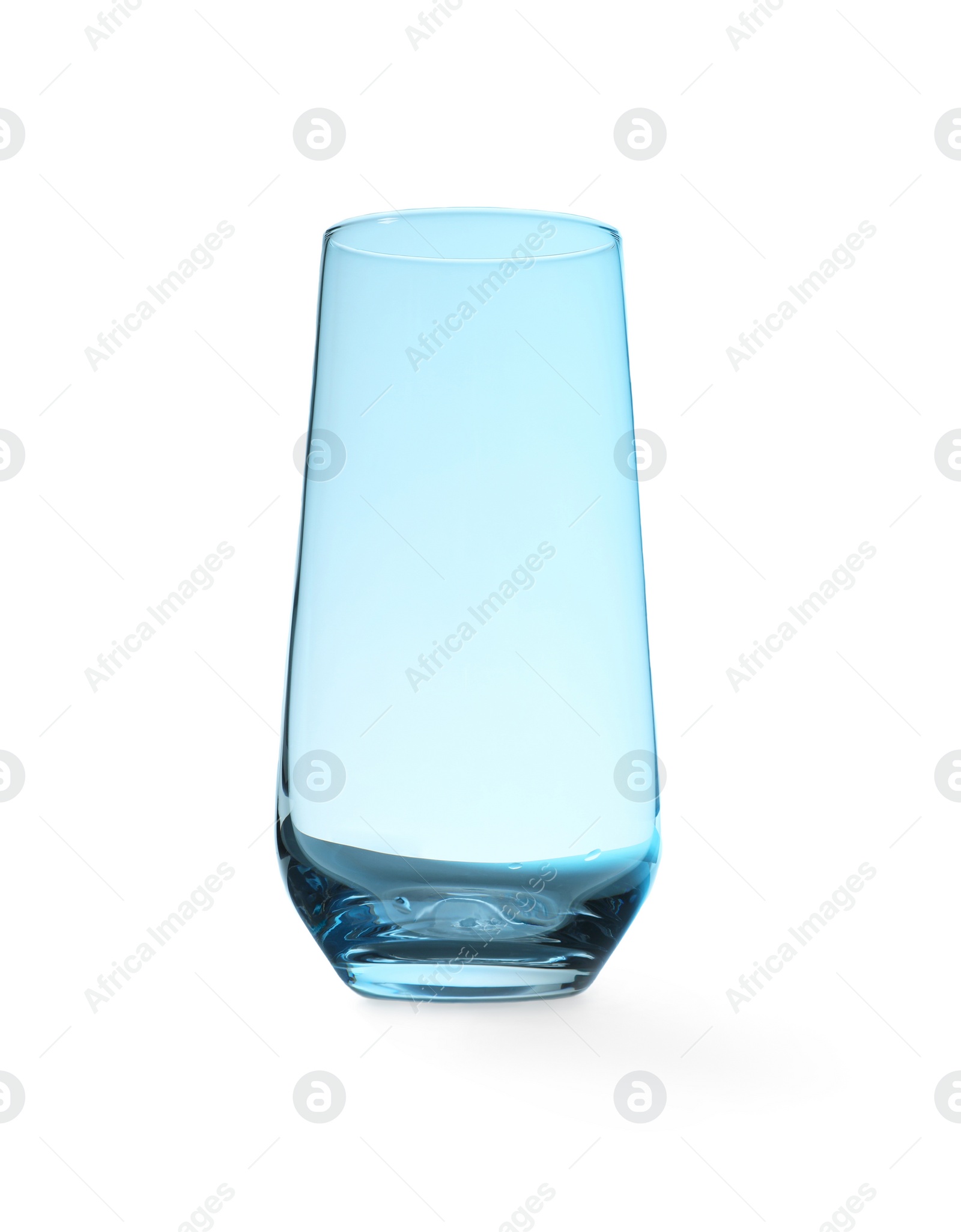 Photo of New empty clear glass on blue background