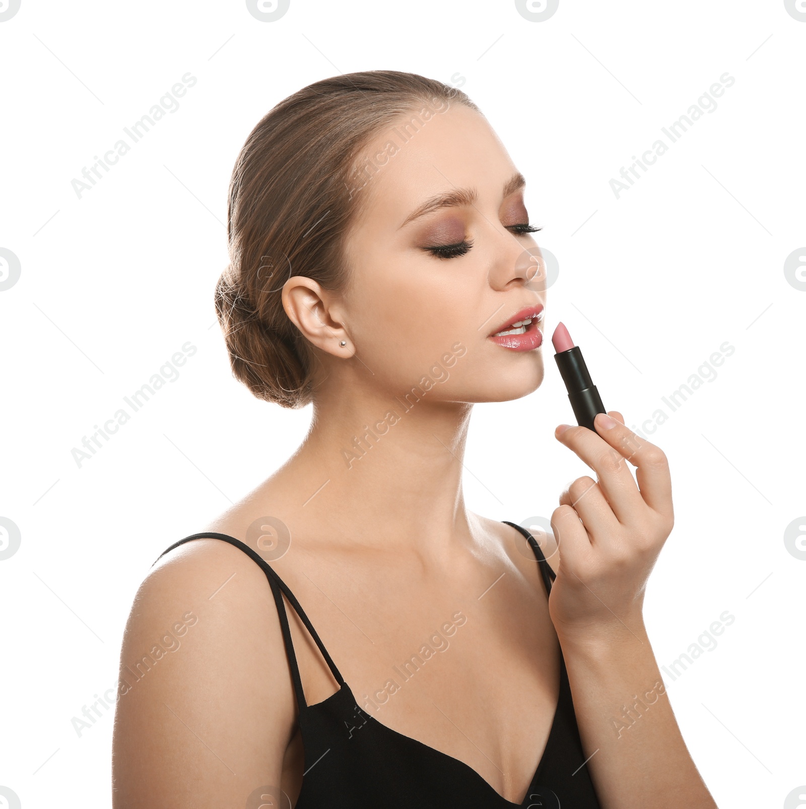 Photo of Beautiful woman applying lipstick on white background. Stylish makeup