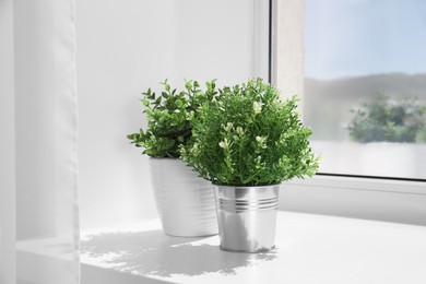 Artificial potted herbs on sunny day on windowsill indoors. Home decor