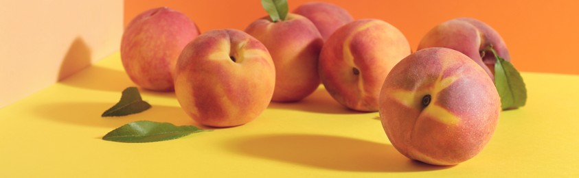 Image of Fresh ripe peaches on color background. Banner design