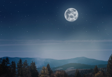 Image of Beautiful landscape with full moon in night sky