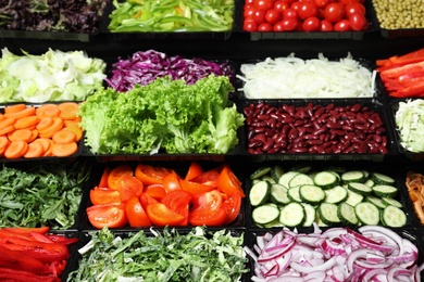 Photo of Salad bar with different fresh ingredients as background