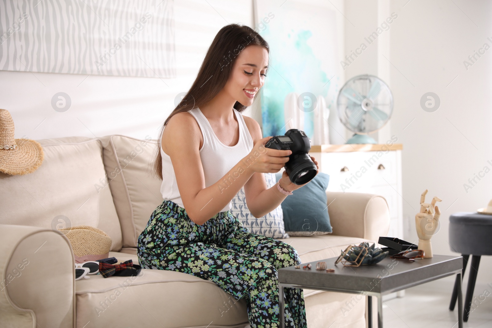 Photo of Young photographer taking picture of jewelry indoors