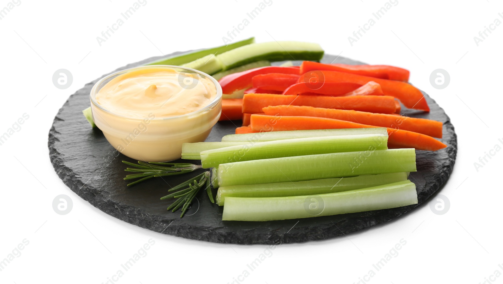 Photo of Slate plate with dip sauce, celery and other vegetable sticks isolated on white