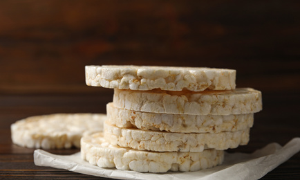 Photo of Stack of crunchy rice cakes on wooden table, closeup