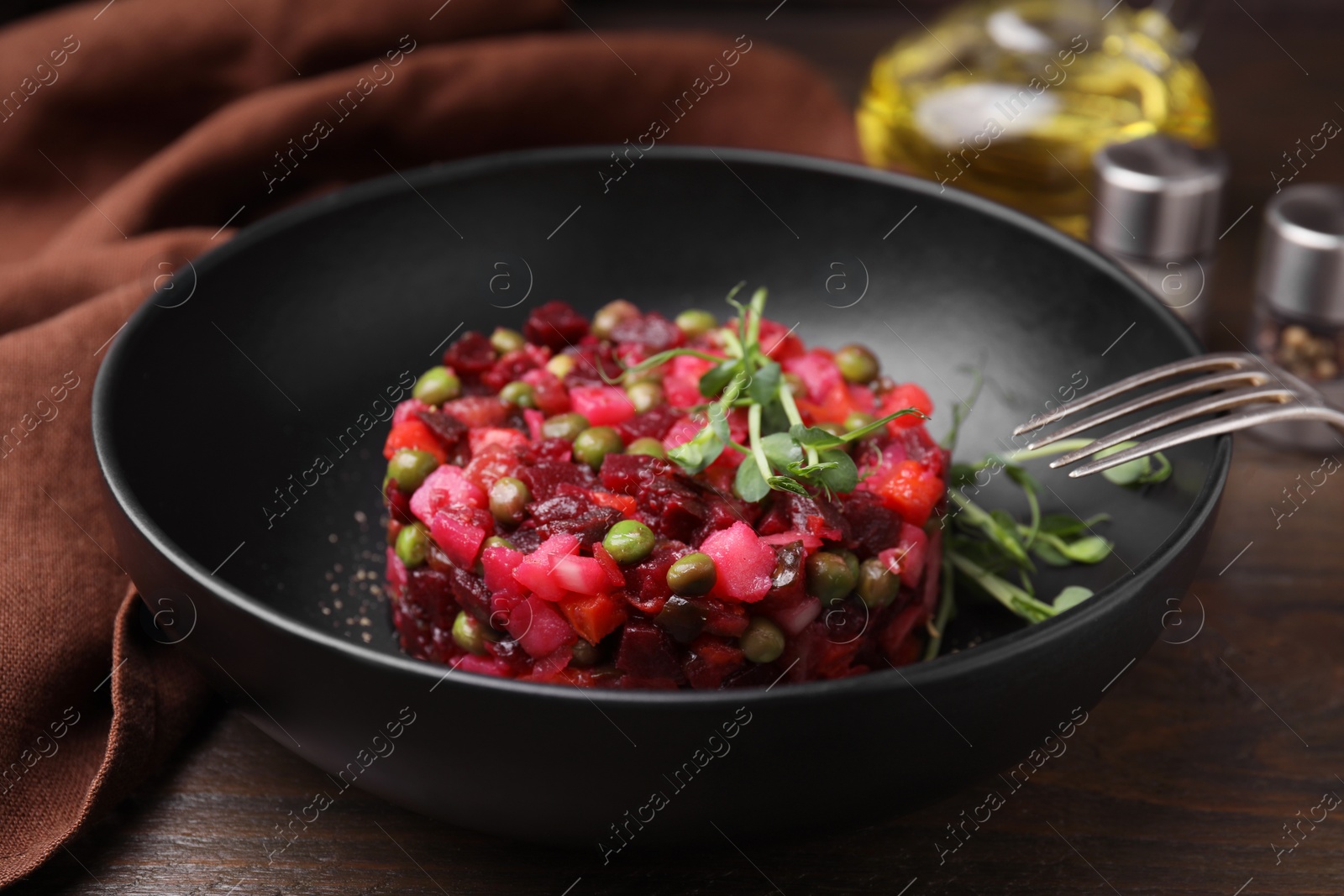 Photo of Delicious vinaigrette salad on wooden table, closeup