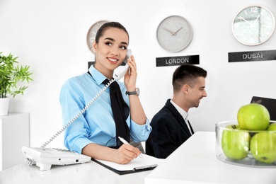 Busy receptionists at workplace in hotel