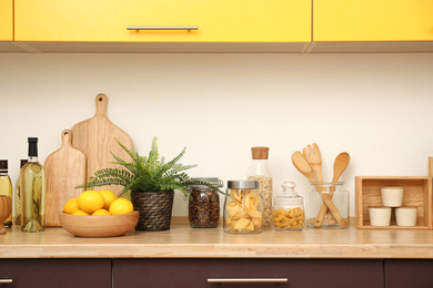 Stylish kitchen interior with wooden countertop and wall cabinets