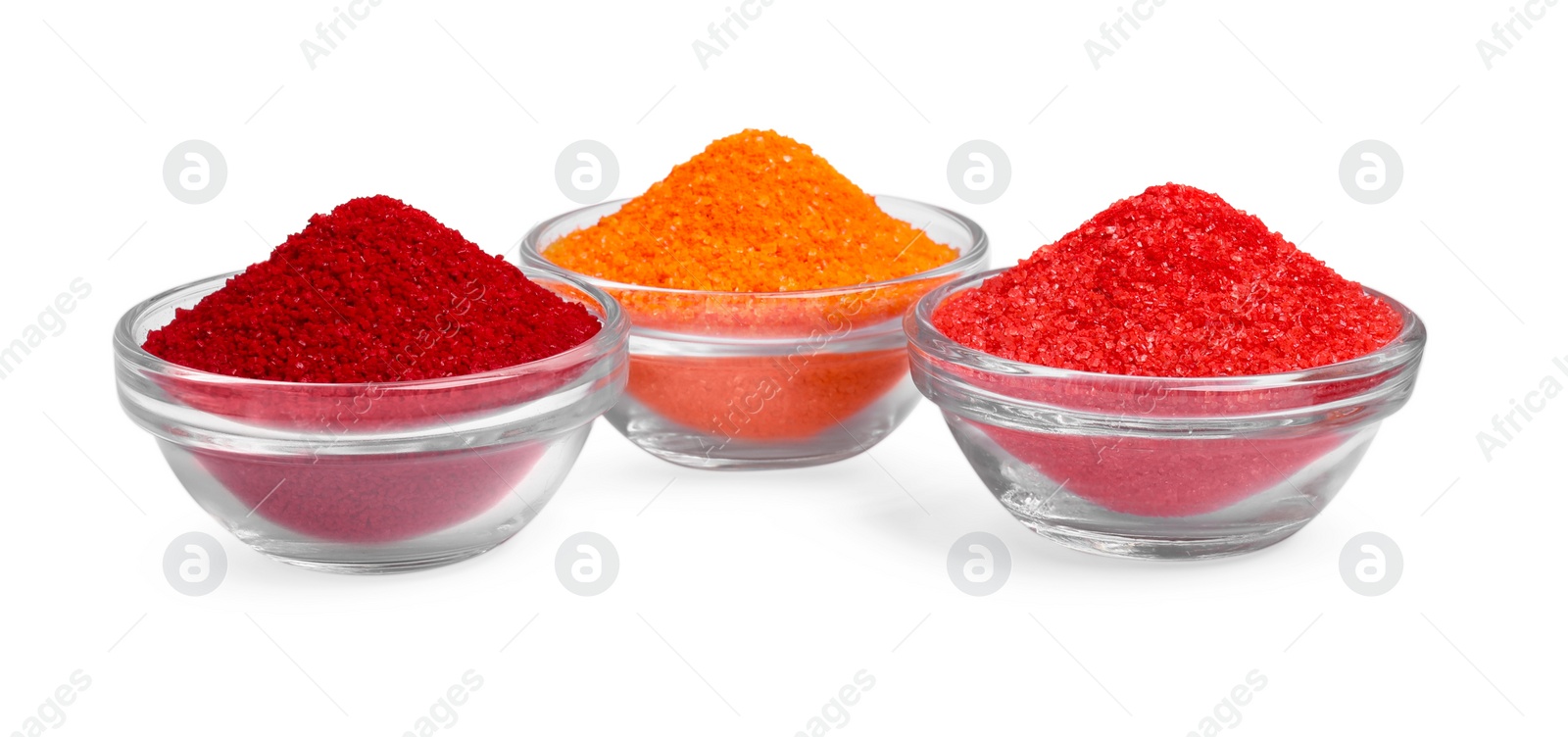 Photo of Glass bowls with different food coloring isolated on white