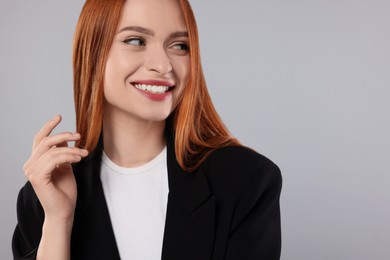 Portrait of beautiful young woman on light gray background, space for text