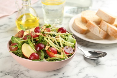 Photo of Delicious fresh celery salad on white marble table