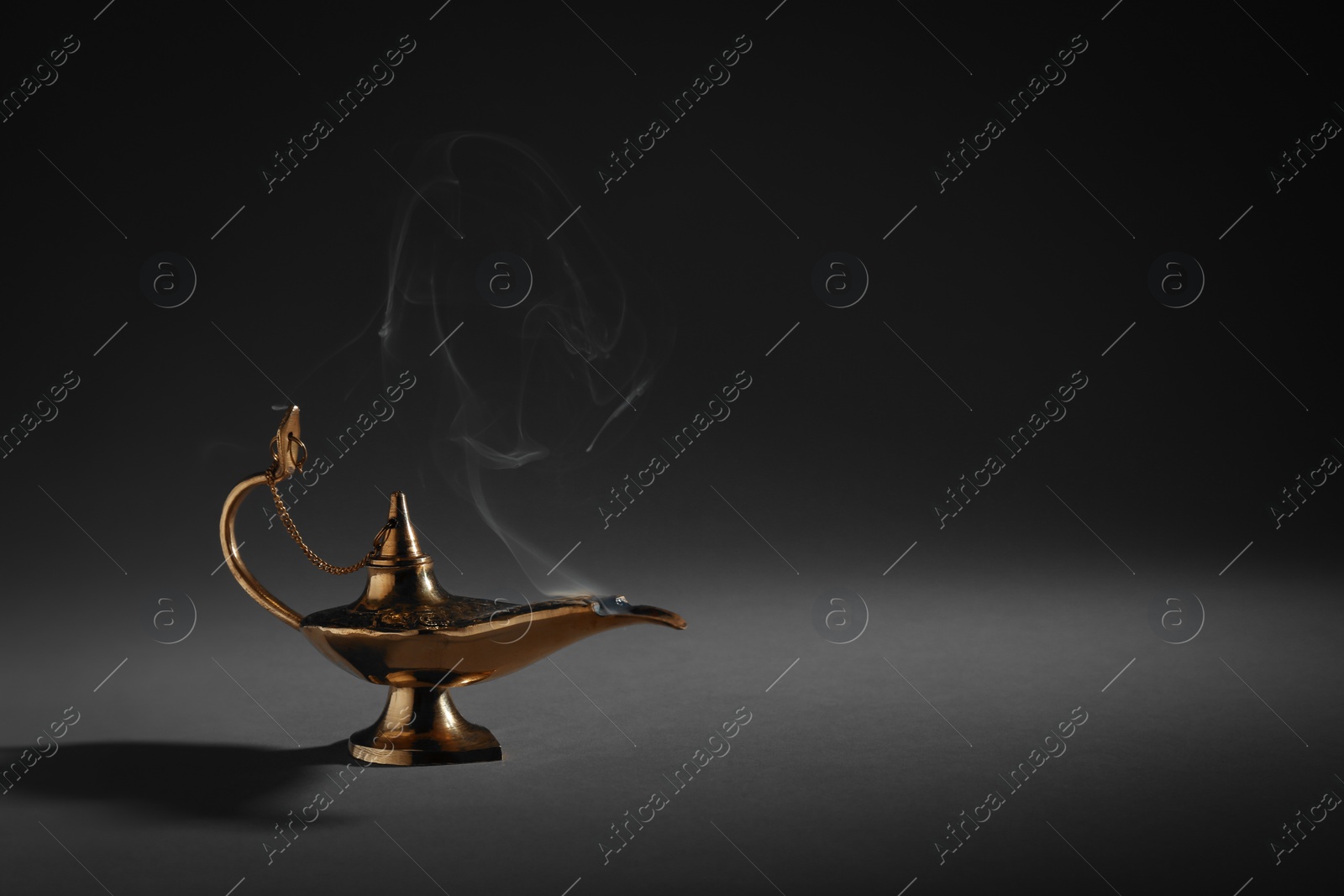 Photo of Aladdin magic lamp on dark background