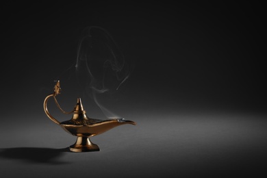 Photo of Aladdin magic lamp on dark background