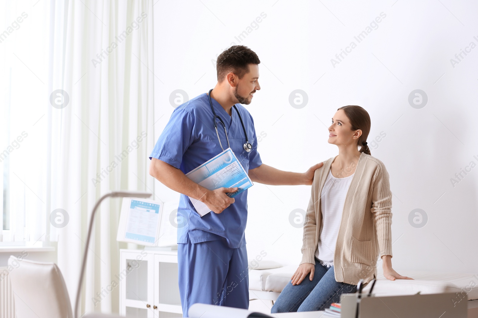 Photo of Doctor consulting patient in his office at hospital