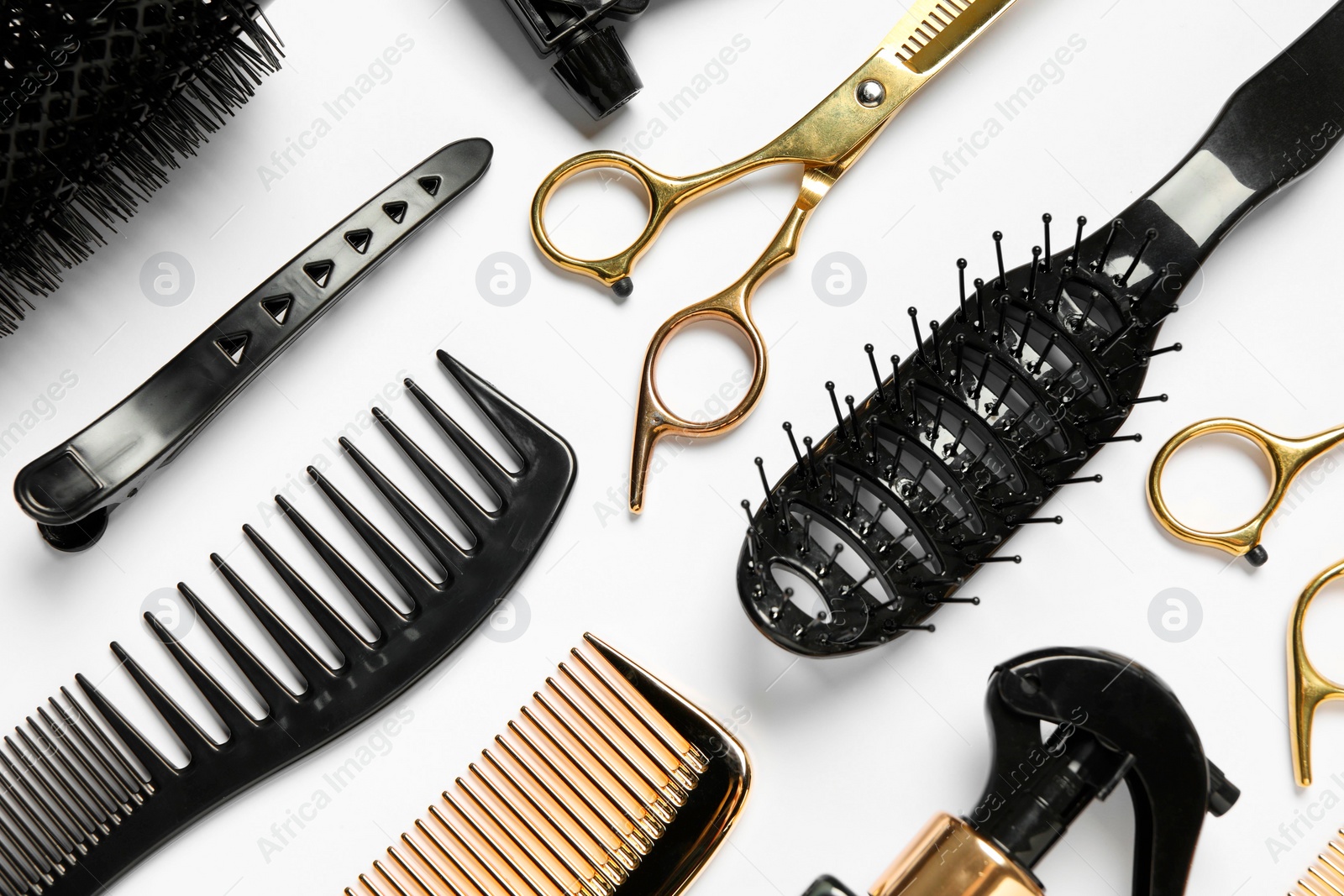 Photo of Hairdressing tools on white background, flat lay