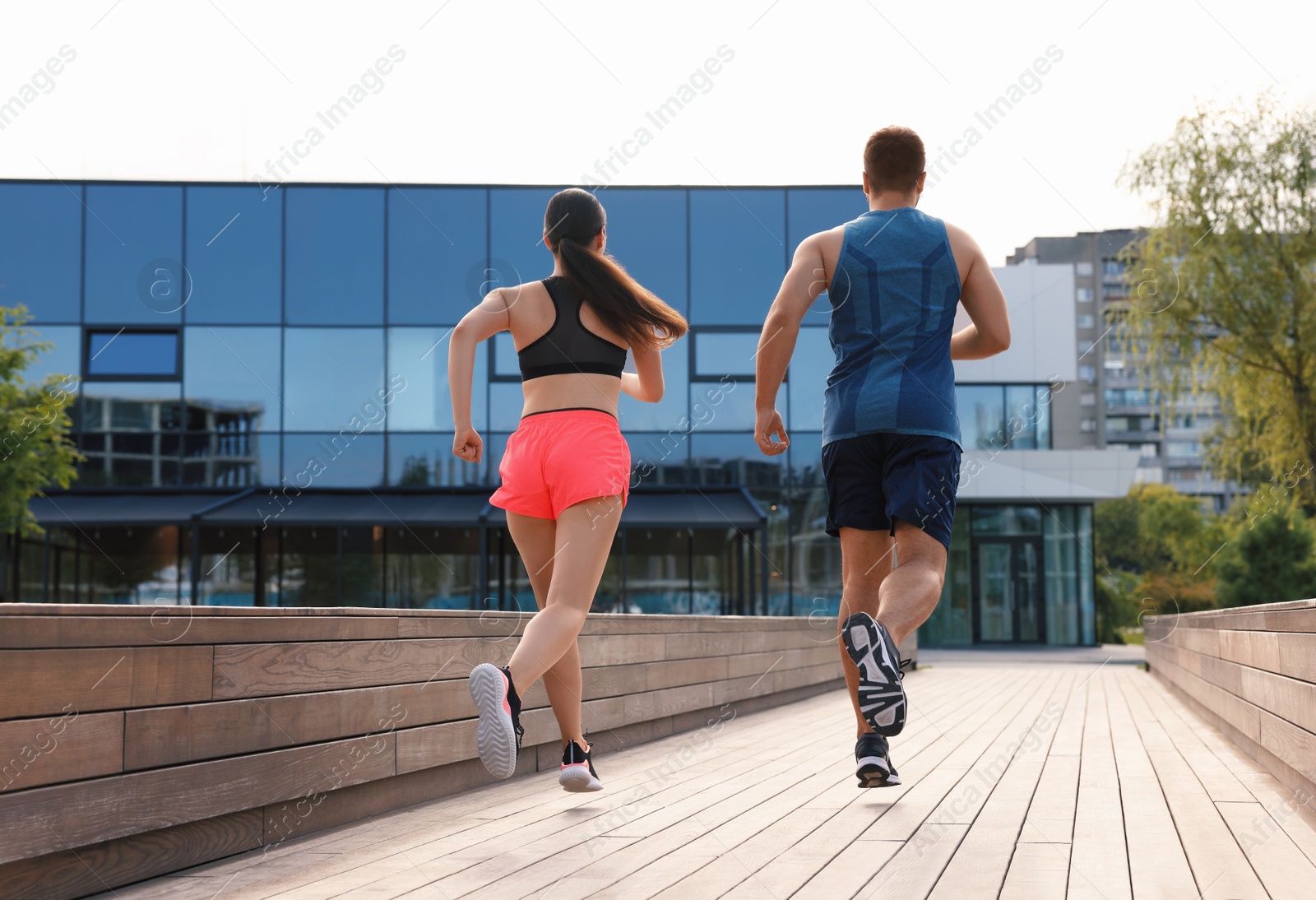 Photo of Healthy lifestyle. Couple running outdoors, low angle view