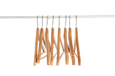 Photo of Wardrobe rack with wooden hangers isolated on white