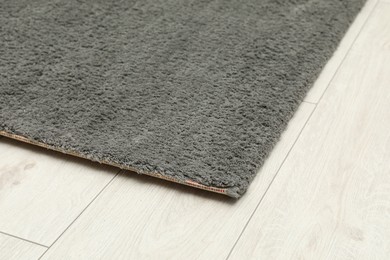 Soft grey carpet on white laminated floor indoors