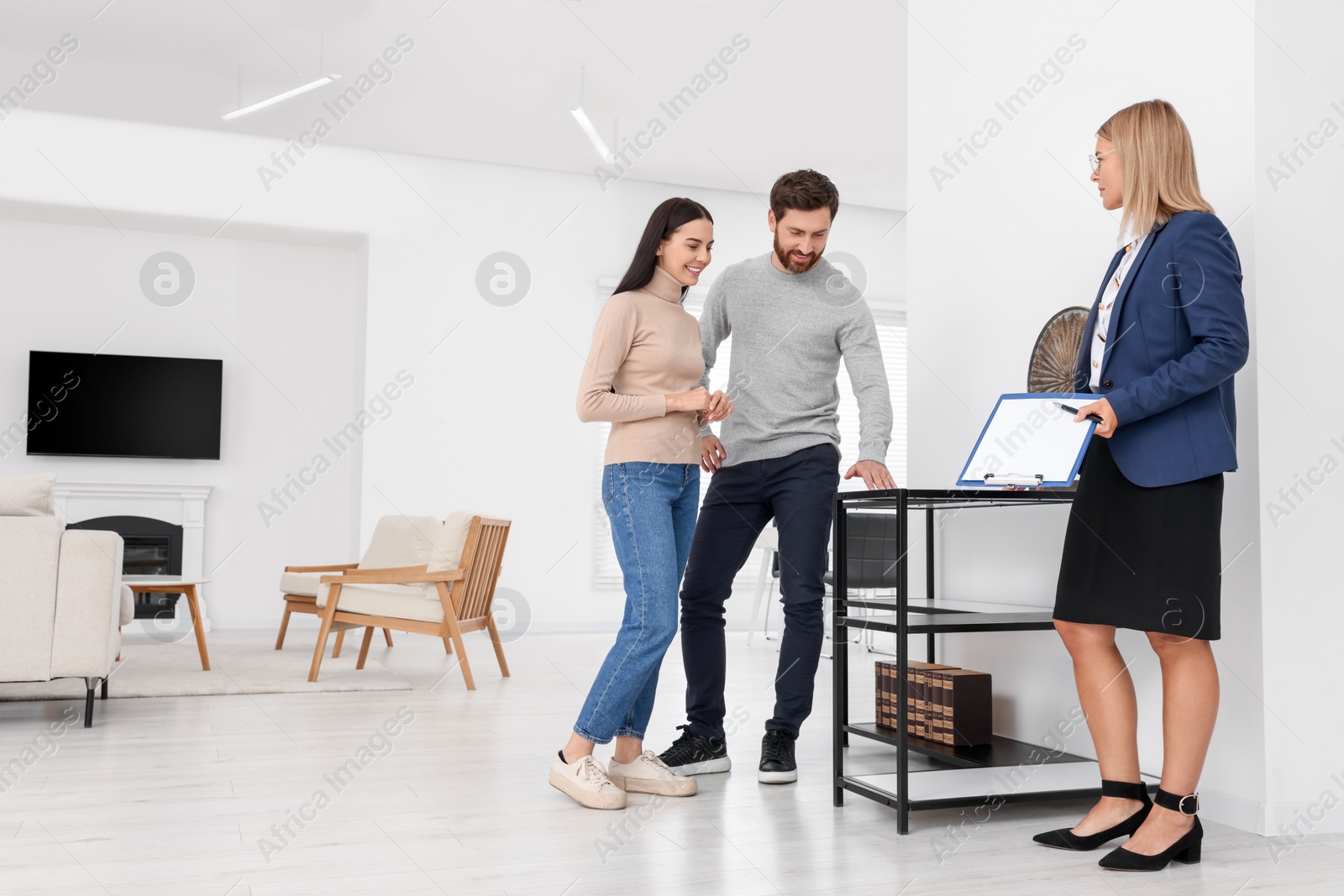 Photo of Real estate agent showing new apartment to couple