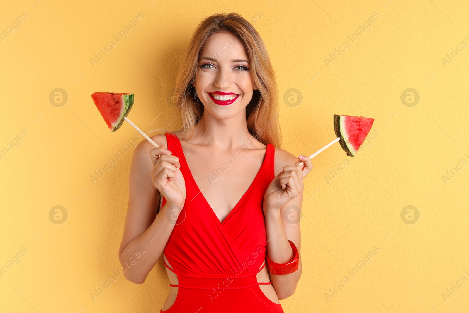 Photo of Pretty young woman with juicy watermelon on color background