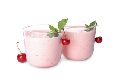 Photo of Tasty fresh milk shakes with cherries on white background