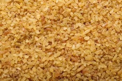 Photo of Pile of uncooked bulgur as background, top view