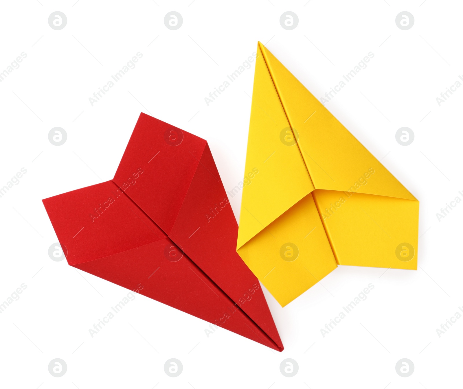 Photo of Handmade yellow and red paper planes isolated on white, top view