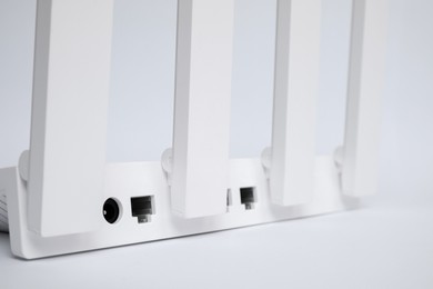 One modern Wi-Fi router on white background, closeup