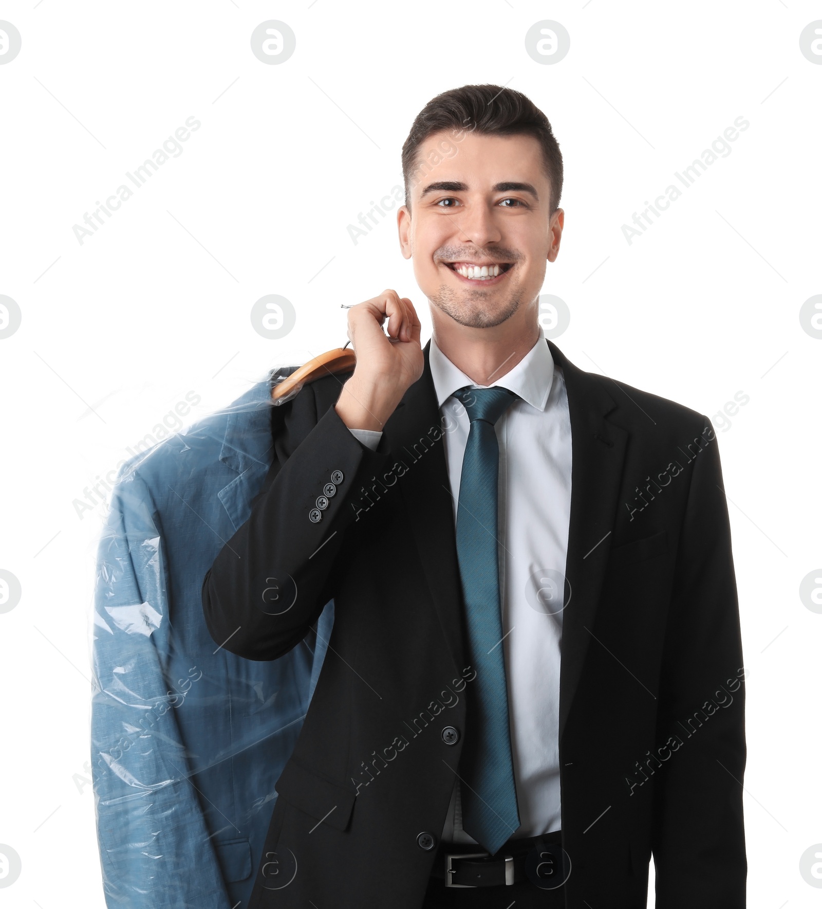 Photo of Young businessman holding hanger with jacket in plastic bag on white background. Dry-cleaning service