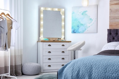 Photo of Room interior with makeup mirror, dressing table and bed