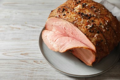 Photo of Delicious baked ham on white wooden table, closeup. Space for text