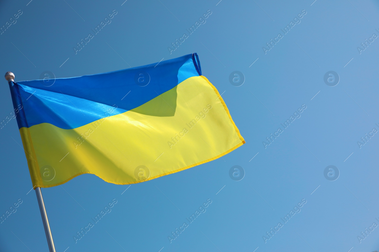 Photo of National flag of Ukraine fluttering on sunny day outdoors