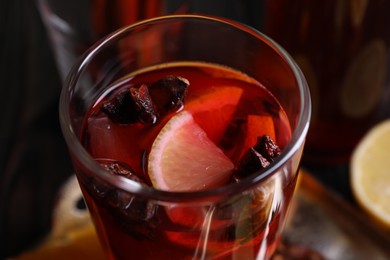 Photo of Glass of aromatic punch drink on table, closeup