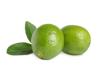 Fresh ripe limes with green leaves isolated on white