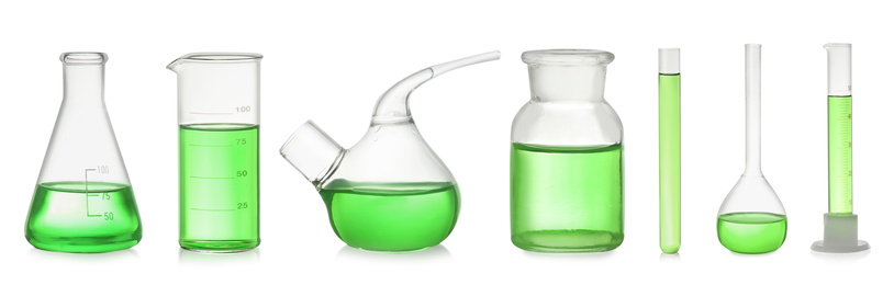 Set of laboratory glassware with green liquid on white background. Banner design