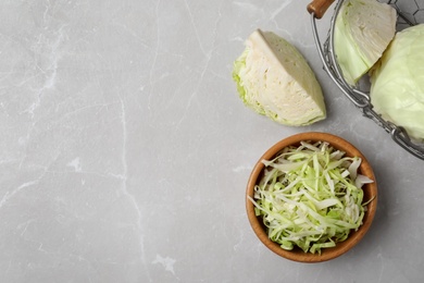Photo of Fresh cut cabbage on light table, flat lay. Space for text