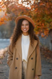 Photo of Portrait of beautiful African-American woman in casual outfit on city street
