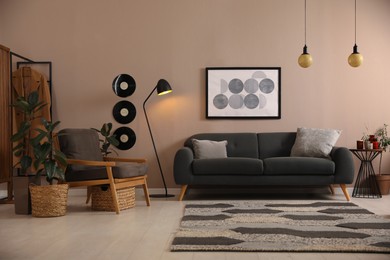 Photo of Stylish living room interior with comfortable dark sofa