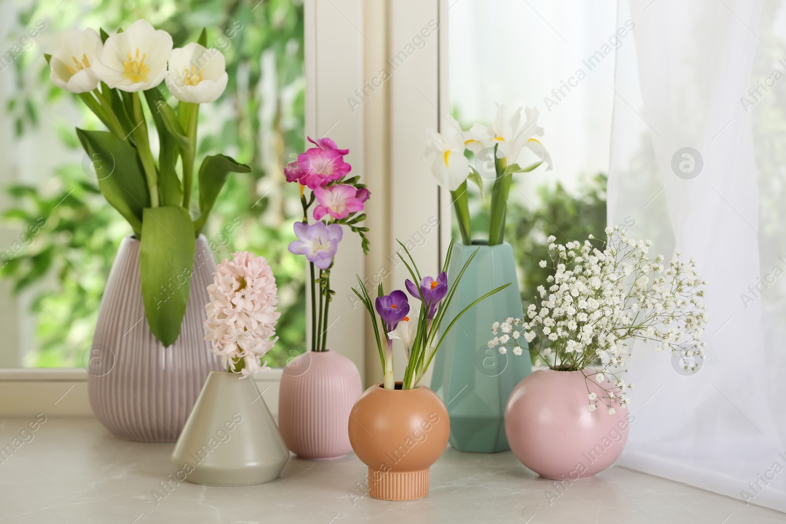 Photo of Beautiful fresh flowers on window sill indoors