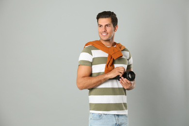 Professional photographer working on light grey background in studio. Space for text