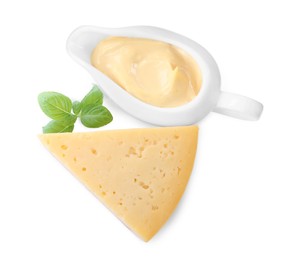 Photo of Tasty cheese, sauce and basil on white background, top view