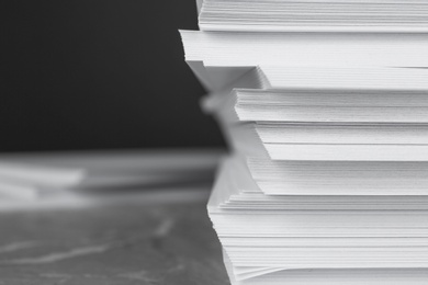 Photo of Stack of blank white paper on table, closeup. Space for text