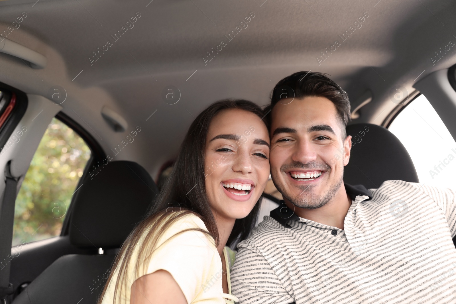 Photo of Happy young couple in car on road trip