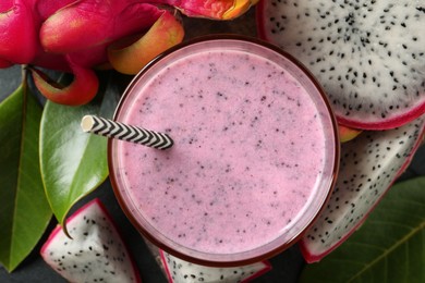 Photo of Delicious pitahaya smoothie and fresh fruits on table, flat lay