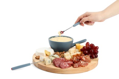 Woman dipping grape into fondue pot with melted cheese on white background, closeup