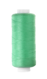 Photo of Spool of green sewing thread isolated on white