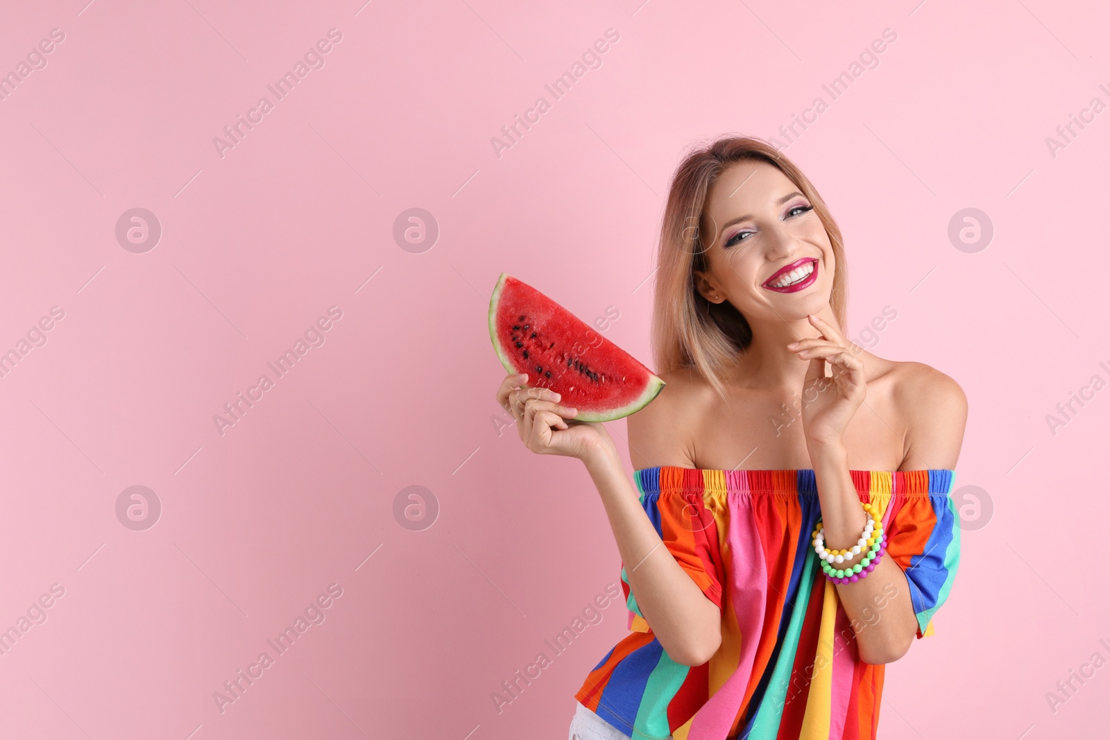 Photo of Pretty young woman with juicy watermelon on color background