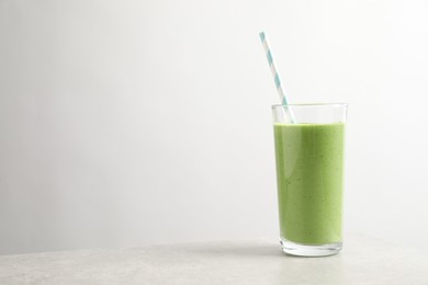 Photo of Tasty kale smoothie on light grey marble table, space for text