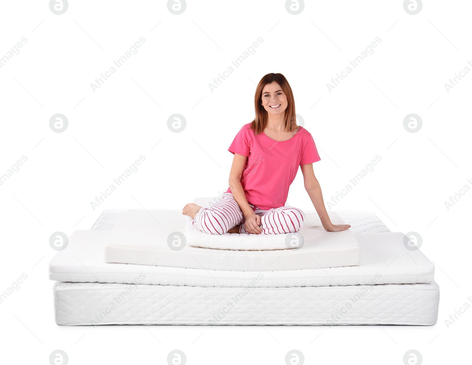 Photo of Woman sitting on mattress pile against white background